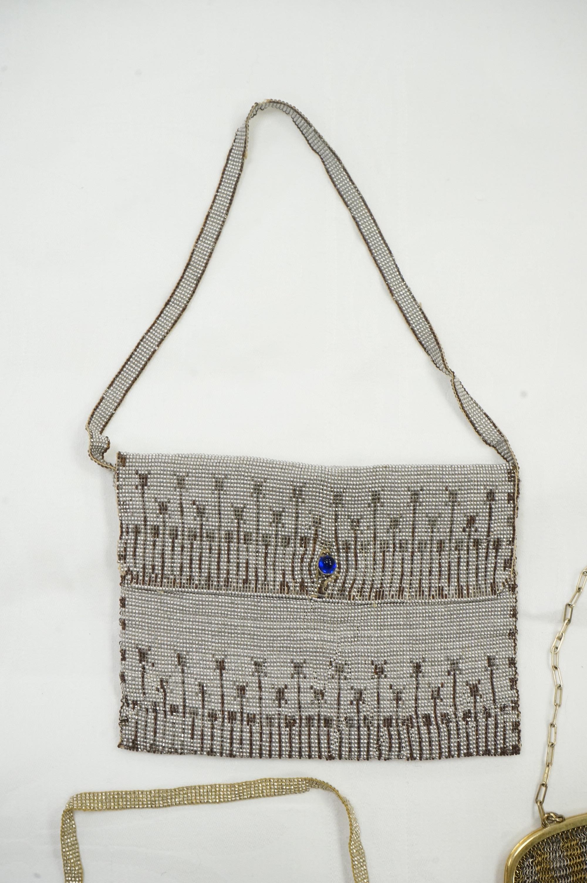 An Art Deco coloured metal chain mail evening bag together with a silver metal bead, blue clasped evening bag and smaller purse., Chain mail bag 13.5cm high. Condition - good on all three.